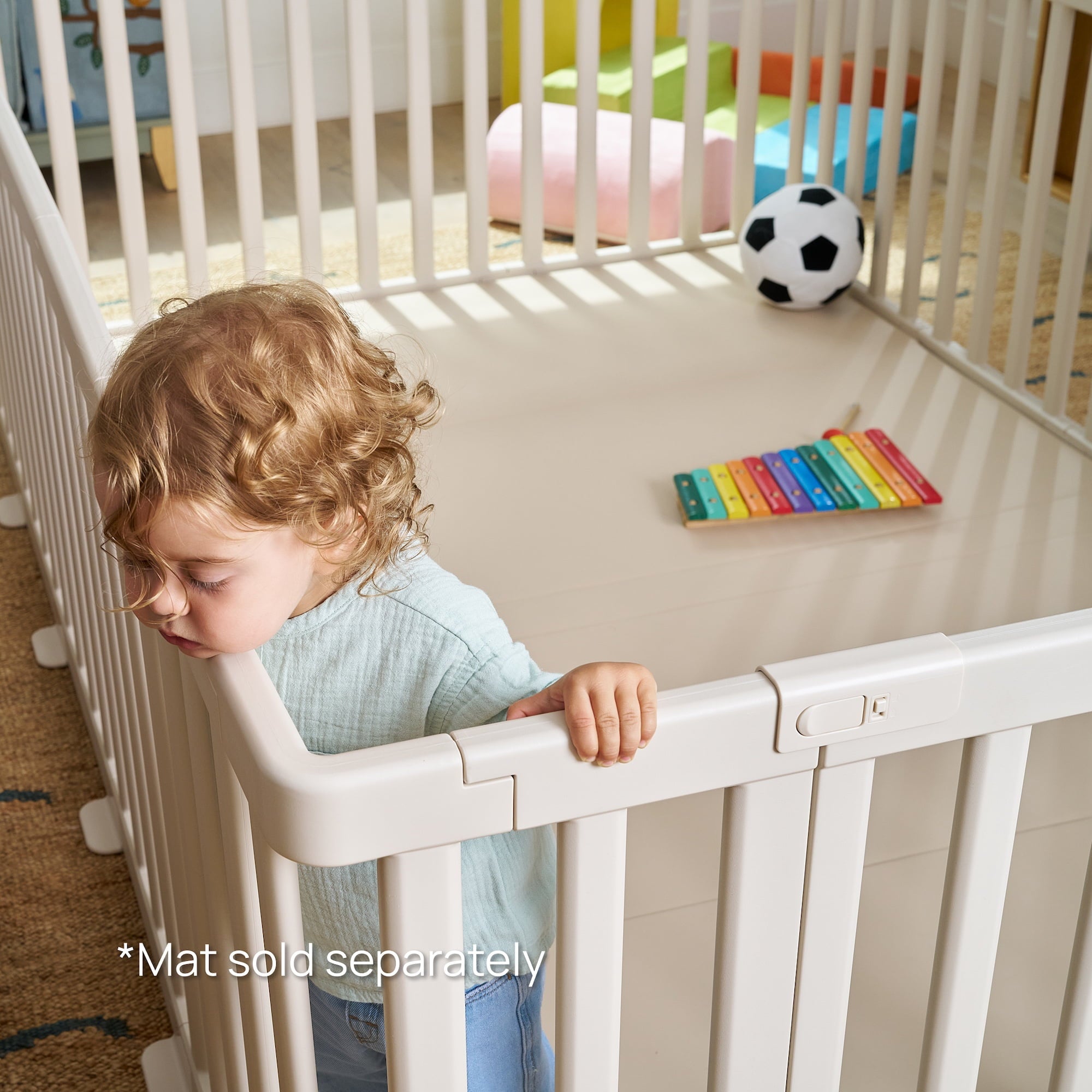 Close-up of child inside premium baby playpen with locking latch detail