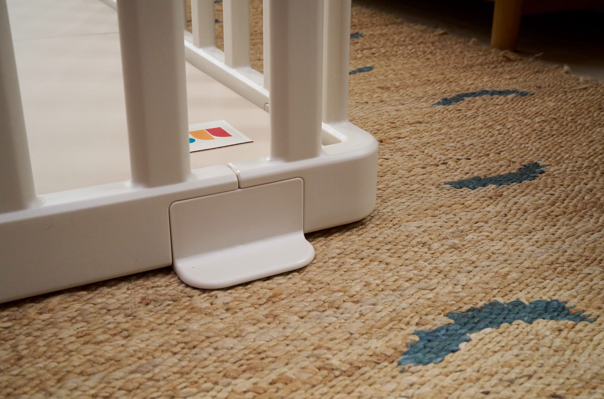 Matty’s Room playpen corner stabilizer foot on woven rug