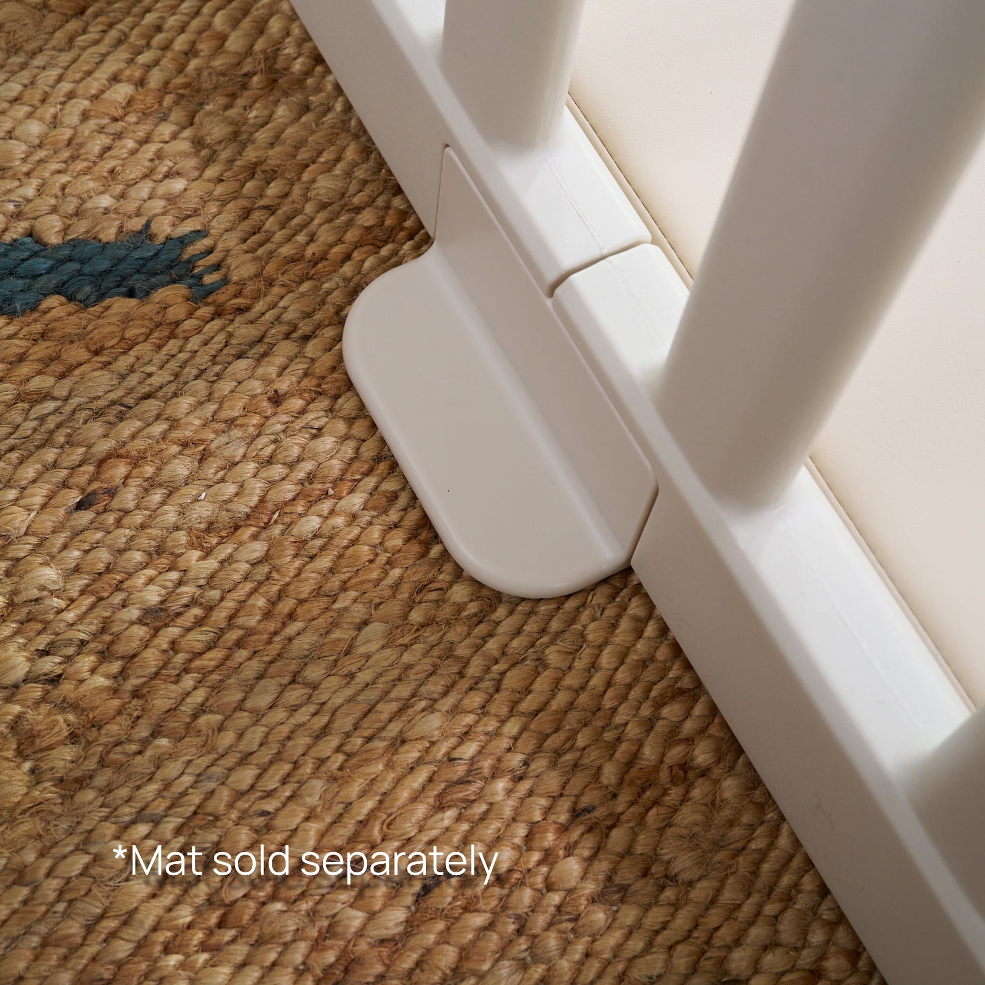 Close-up of anti-slip baby playpen stabilizer foot (Safety Stoppy™) on woven rug