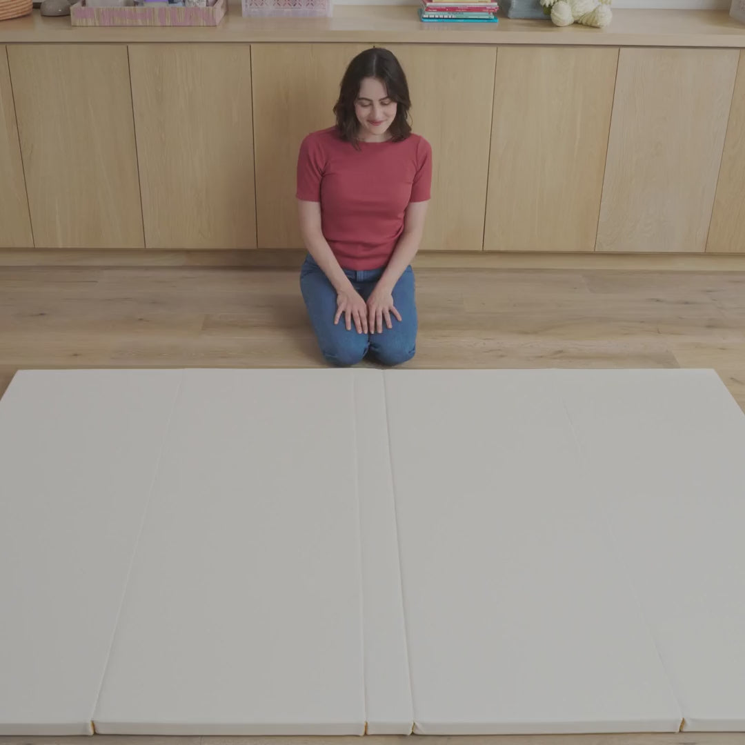 Premium, non-toxic cushioned baby play mat folding and unfolding to show flexible design